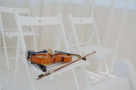 Beautiful vintage old violin in white interiorの写真素材