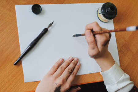 Female artist paint hand writing chinese calligraphyの写真素材