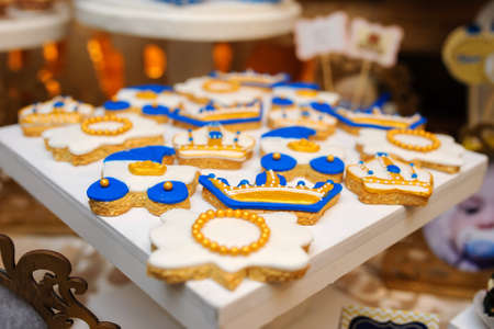 Sweet cookies with white cream  decorated with gold, royal style の写真素材