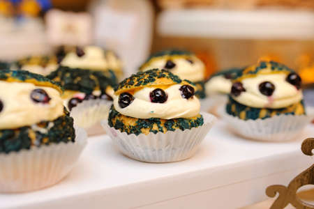 Sweet cookies muffins basket with cream in a paper wrapper decorated with currantの写真素材