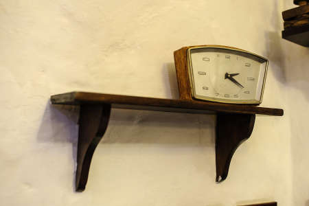 Old vintage clock on a wood shelf , decoration interiorの写真素材