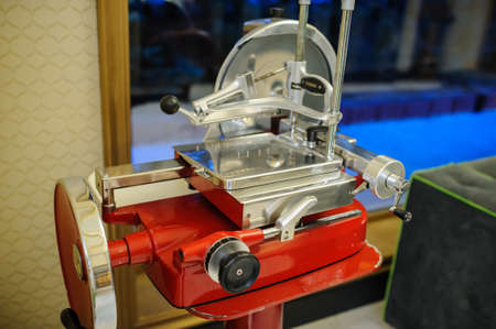 vintage old ham prosciutto red slicer in an italian restaurantの写真素材