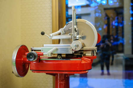 vintage old ham prosciutto red slicer in an italian restaurantの写真素材