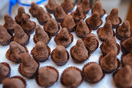 Sweet cookies chocolate pyramid in a paper wrapper decorated with sugarの写真素材
