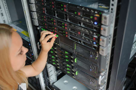 woman it engeneer work in modern interior of server room in datacenter.の写真素材