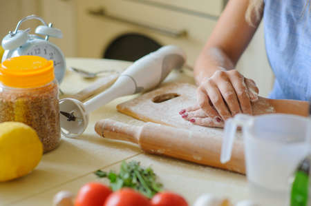 close up hands of young woman with flour in the kitchen, cooking timeの写真素材