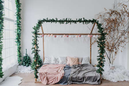 Vintage style interior decorated with  christmas tree bed  and artificial snowの写真素材