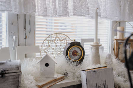 close up composition of vintage old white books, cage and clockの写真素材