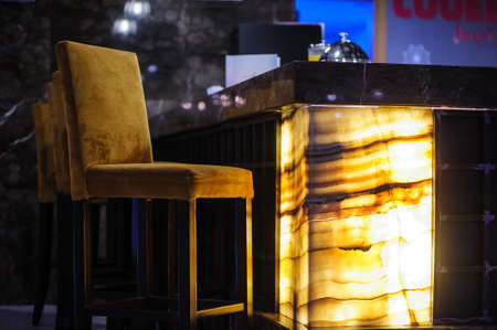 couch and chiart in a lobbby of a restaurant with lightの写真素材