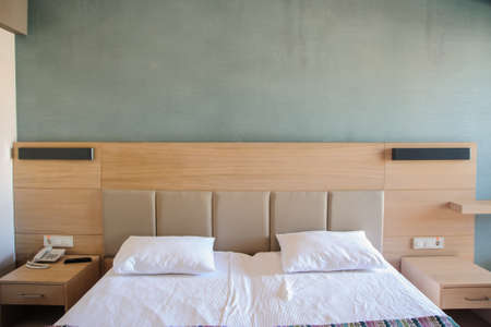 hotel room in a modern minimalist style with bed and candelabreの写真素材