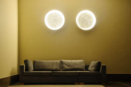 couch and chiart in a lobbby of a restaurant with lightの写真素材