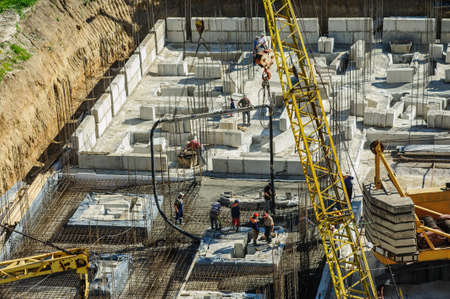 iron structure on a construction site of a building with workersの写真素材