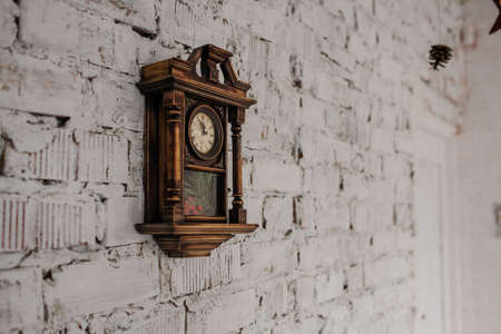 Old Vintage wood clock on the brick wall painted in white, part of decorの写真素材