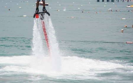 man riding high on the water at the seasideの写真素材