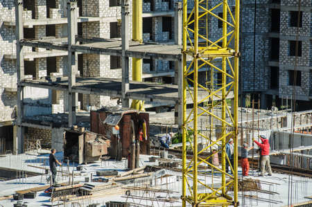 iron structure on a construction site of a building with workersの写真素材