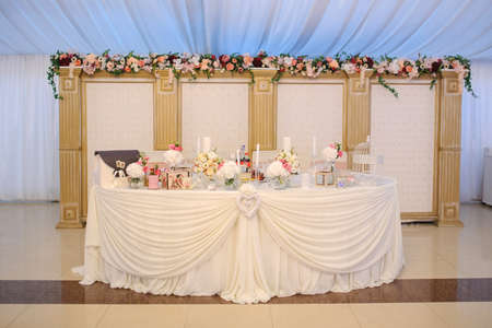 Wedding table decorated with flowers: hortensia, roses and eustoma. Design elements: box, candles and watering.の写真素材