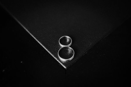 Design concept of vintage wedding rings in a black corner. Black and white b&w