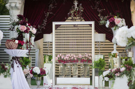 Wedding Wall for photo session decoration outdoor, Red flowers decoration  from: roses, hortensia and ranunculus. Petals on the floorの写真素材