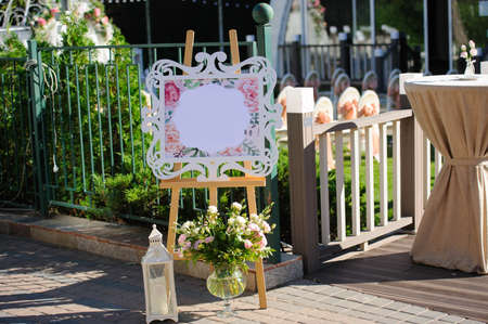 Design elements for wedding: white panel for information and bouquet with eustoma in vaseの写真素材
