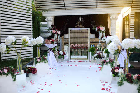 Wedding Wall for photo session decoration outdoor, Red flowers decoration  from: roses, hortensia and ranunculus. Petals on the floorの写真素材