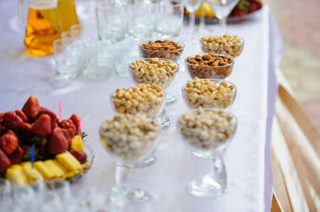 Nuts at a banquet on the table in glass trayの写真素材