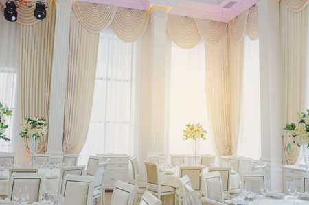 The banquet hall with round tables, with cutlery, clouse viewの写真素材