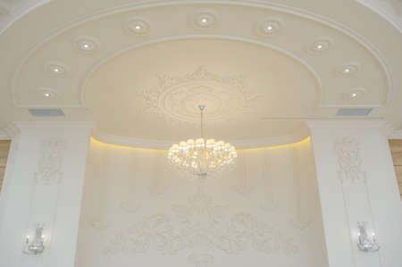 White glass chandelier in a banquet hall, down viewの写真素材