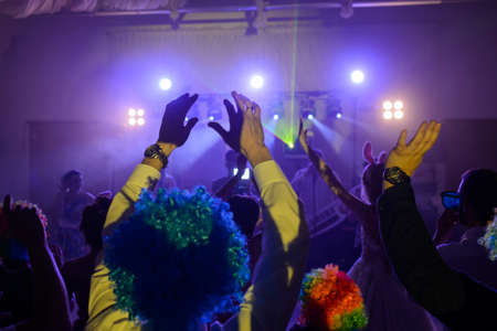 The party, dancing on the floor, colorful lights, hands upの写真素材