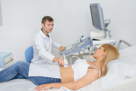 The pregnant lady pacient at ultrasonography examination, close viewの写真素材