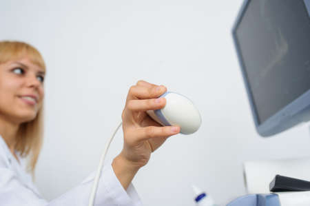 The doctor using the ultrasonography device, close viewの写真素材