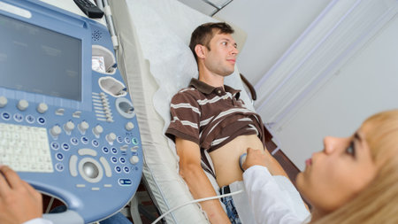 The lady  doctor  examination a man at abdomen with ultrasonography device