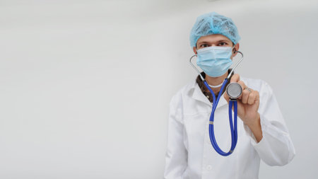 The doctor with the masck and stethoscope in hand, close view