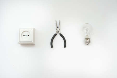 A light bulb ready to be installed, close view, white backgroundの写真素材