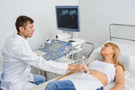 The pregnant lady pacient at ultrasonography examination, close viewの写真素材