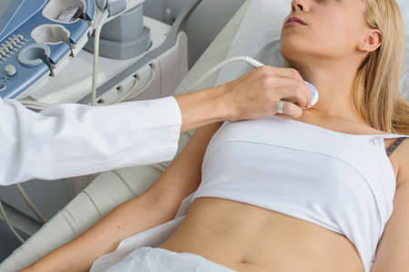 The lady pacient at ultrasonography examination at the neck, close viewの写真素材