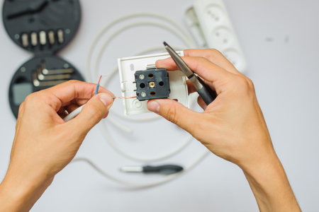 The work process of an electrician, close view, white background