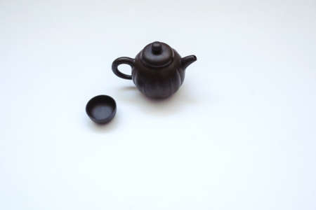 A ceramic kettle with cups, close view, white backgroundの写真素材