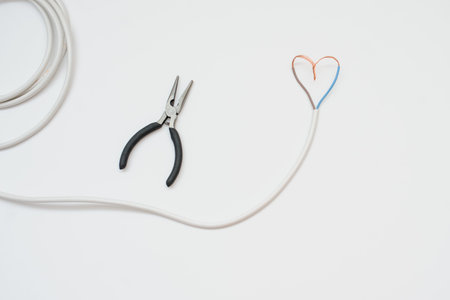 The white wire in the form of heart, white background