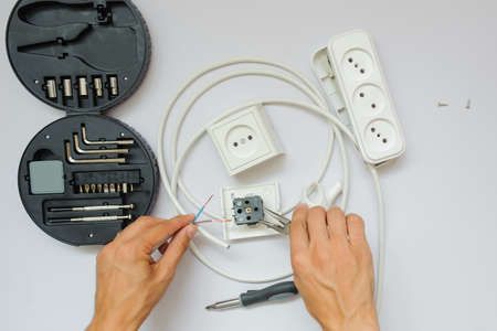 The work process of an electrician, close view, white backgroundの写真素材