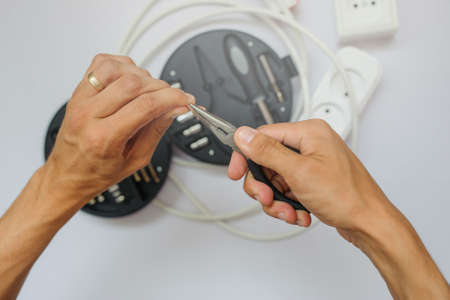 The work process of an electrician, close view, white backgroundの写真素材