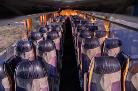 A row of seats in a bus. Front view of empty seats in the bus.の写真素材