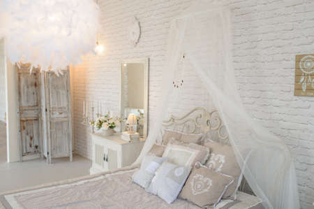 Bed in a photo studio with wedding decoration and soft light.の写真素材