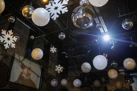 Party disco decorations with lights and christmass balls. View of the decorations on the ceiling.の写真素材