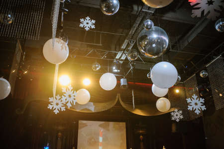 Party disco decorations with lights and christmass balls. View of the decorations on the ceiling.の写真素材