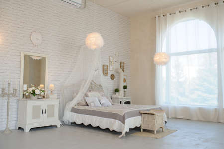 Bed in a photo studio with wedding decoration and soft light.の写真素材