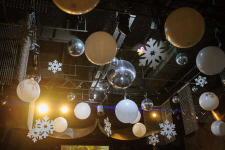 Party disco decorations with lights and christmass balls. View of the decorations on the ceiling.の写真素材