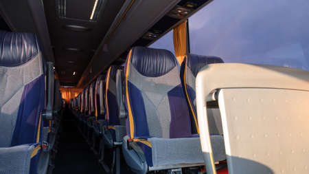 A row of seats in a bus. Front view of empty seats in the bus.の写真素材