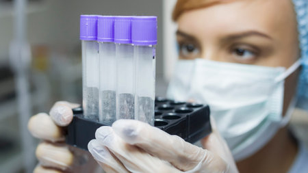 lateral view of a woman with mask looking at tubes