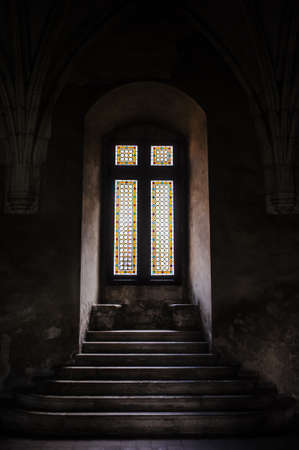 big window in the dark near the stairsの写真素材