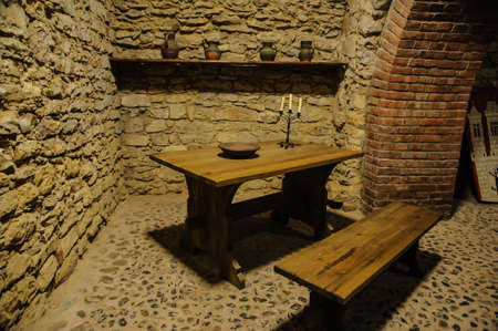 wooden table with chair in the stone room of a castleのeditorial素材